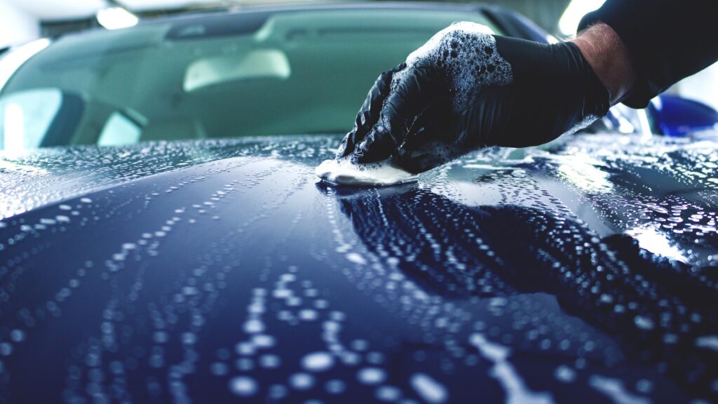 Using a clay bar on a car in Southampton to remove contaminants and improve paint smoothness and shine.